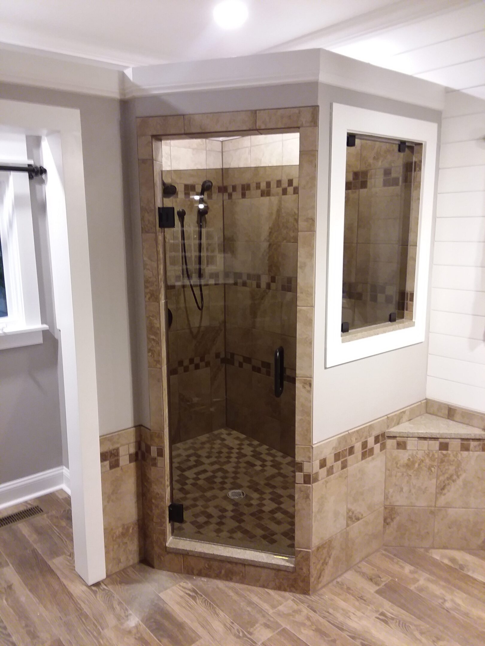 A bathroom with a shower and tiled walls.