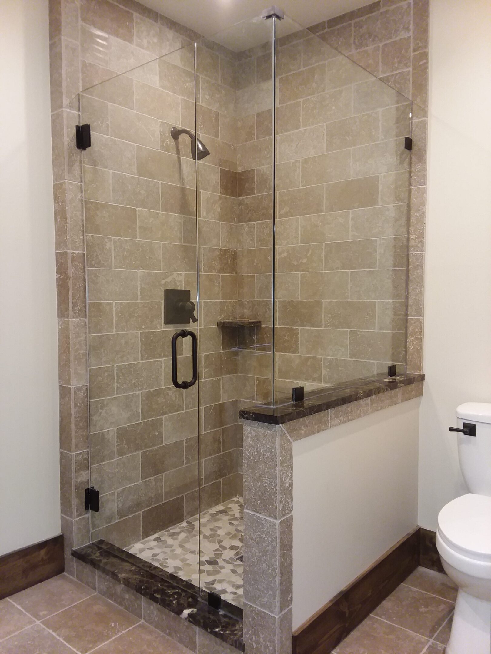 A bathroom with a shower and toilet in it