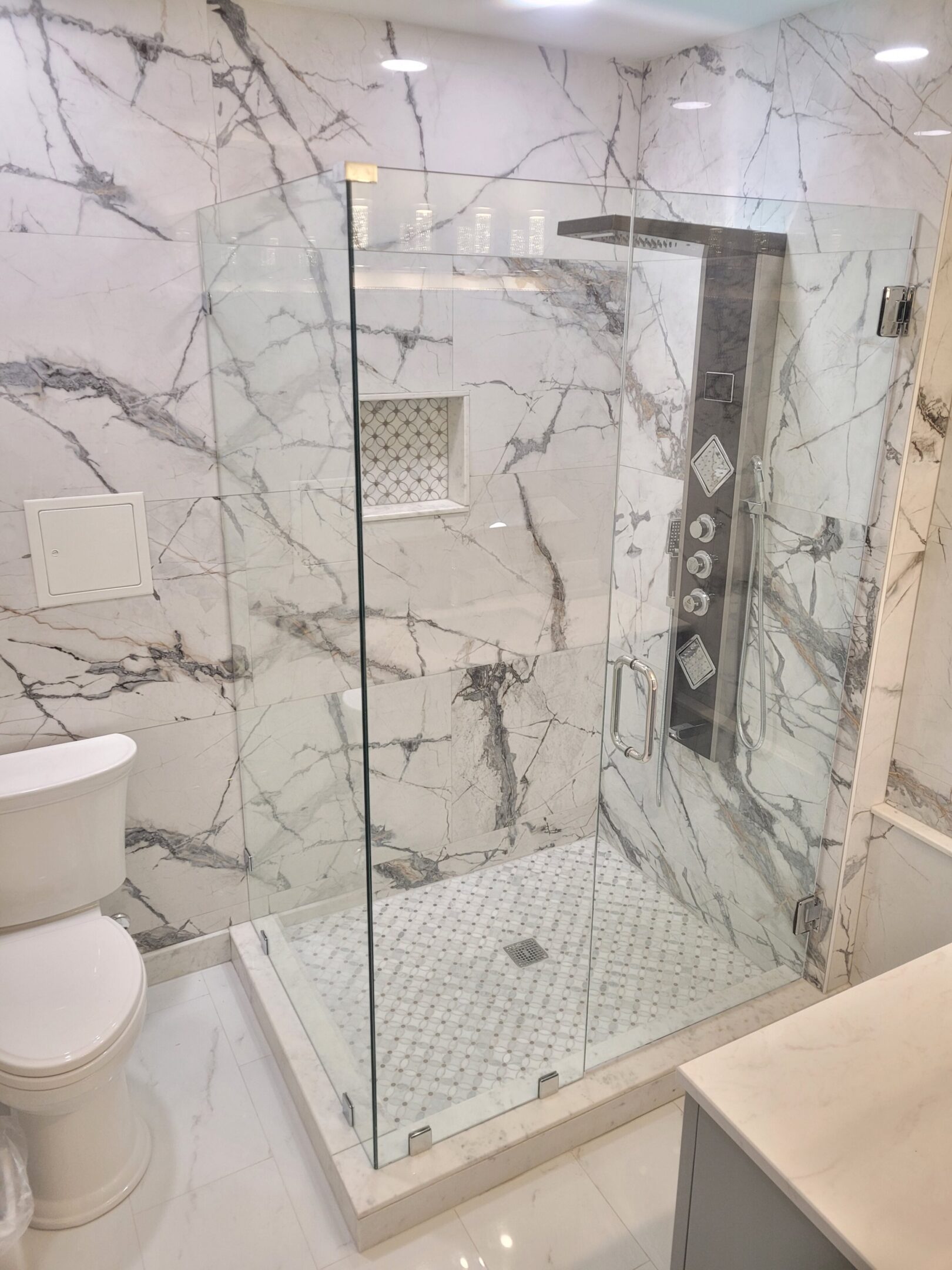 A bathroom with marble walls and floors.