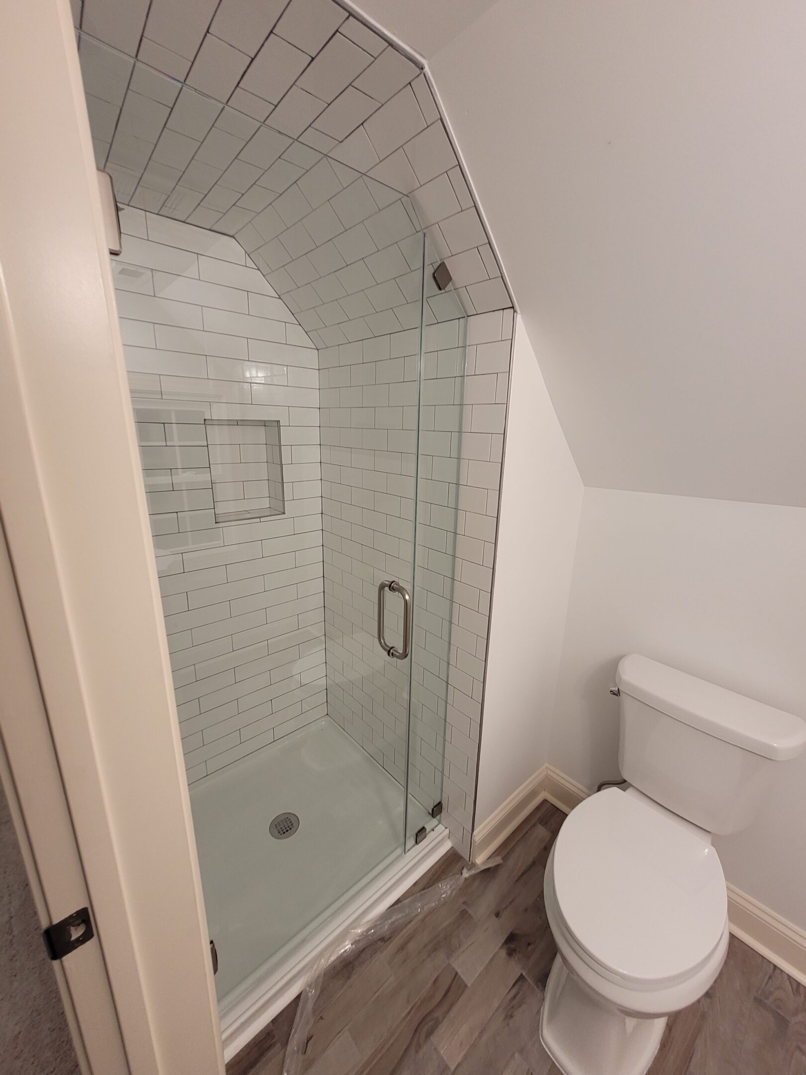 A bathroom with a toilet and shower in it