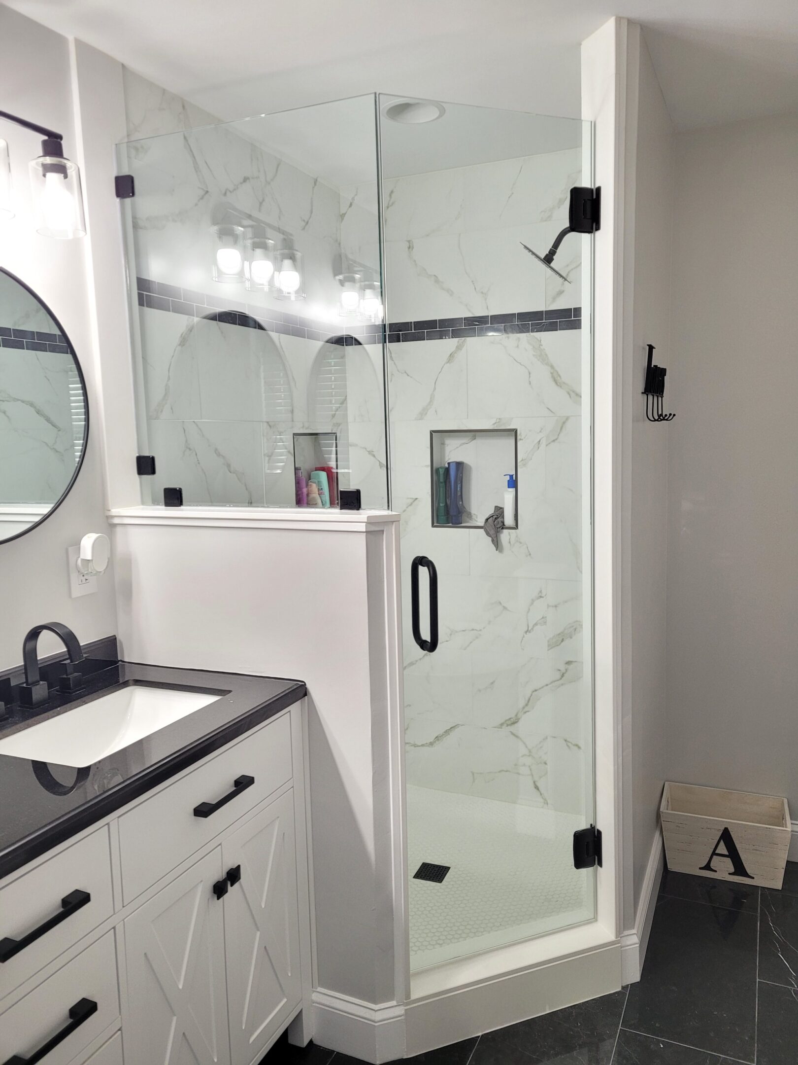 A bathroom with a sink, mirror and shower.