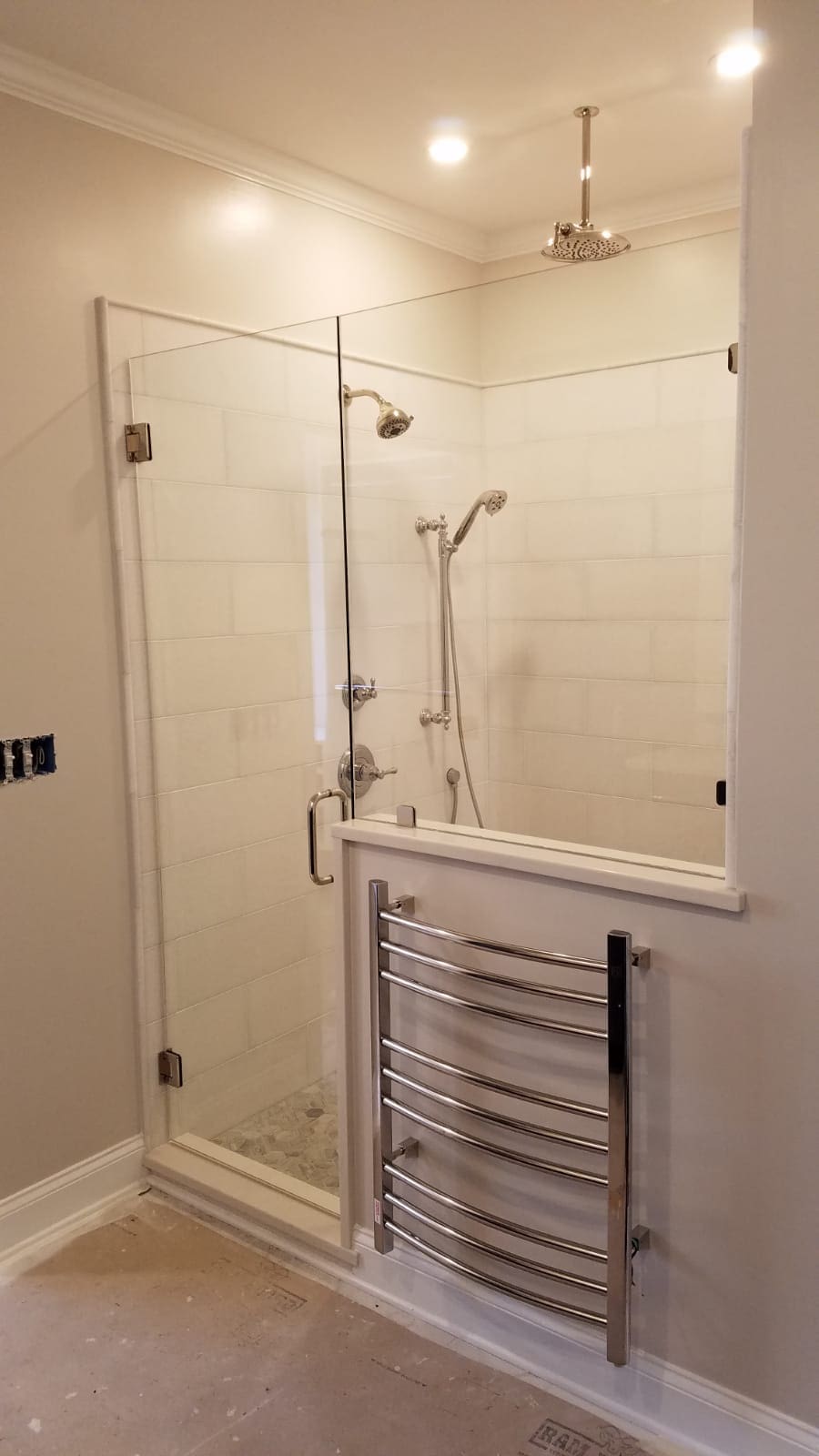 A bathroom with a shower and tiled walls.