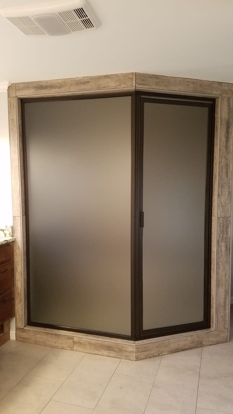 A large glass door in the corner of a room.