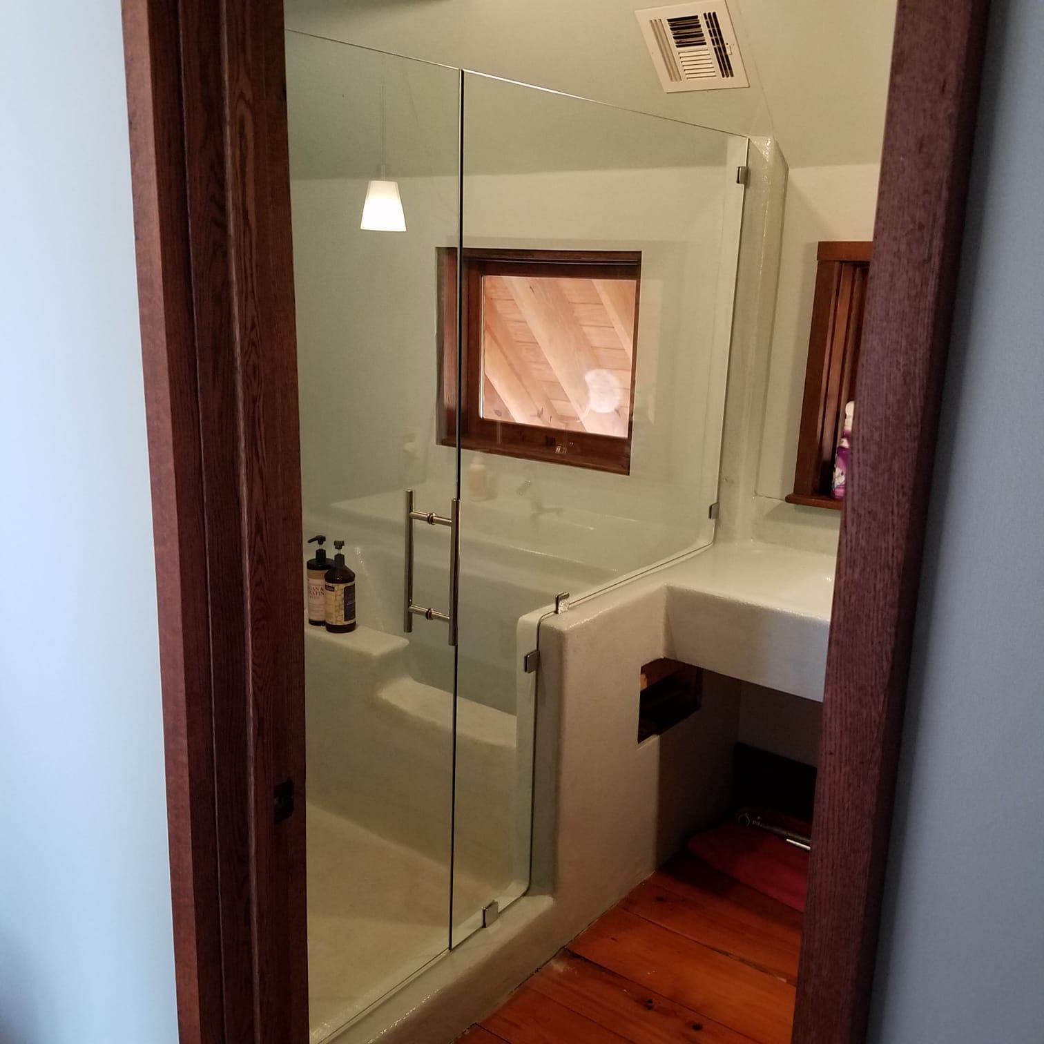 A bathroom with a shower and tub in it