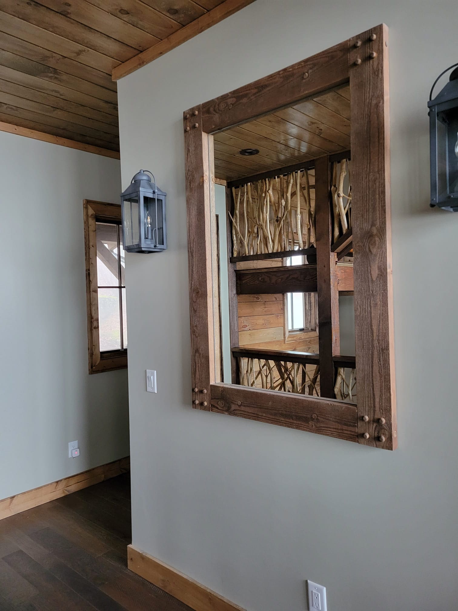 A mirror hanging on the wall in a room.