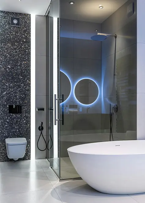 A bathroom with a large glass shower and a white toilet.