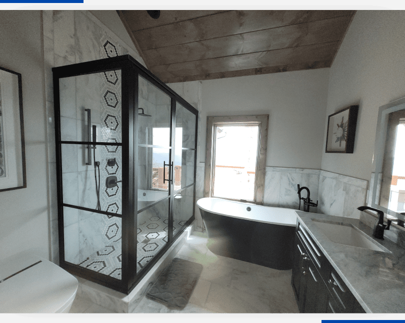 A bathroom with a tub and shower in it